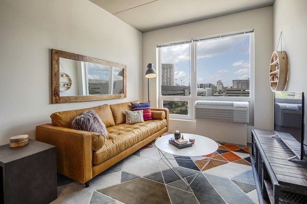 Open-plan living room with modern furnishings at The Hamilton I Apartments