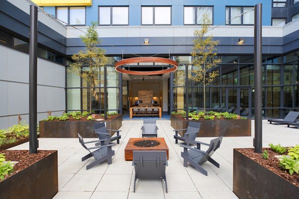 Fire pit area with cozy seating at The Hamilton I Apartments, perfect for gathering and relaxation in a luxury setting