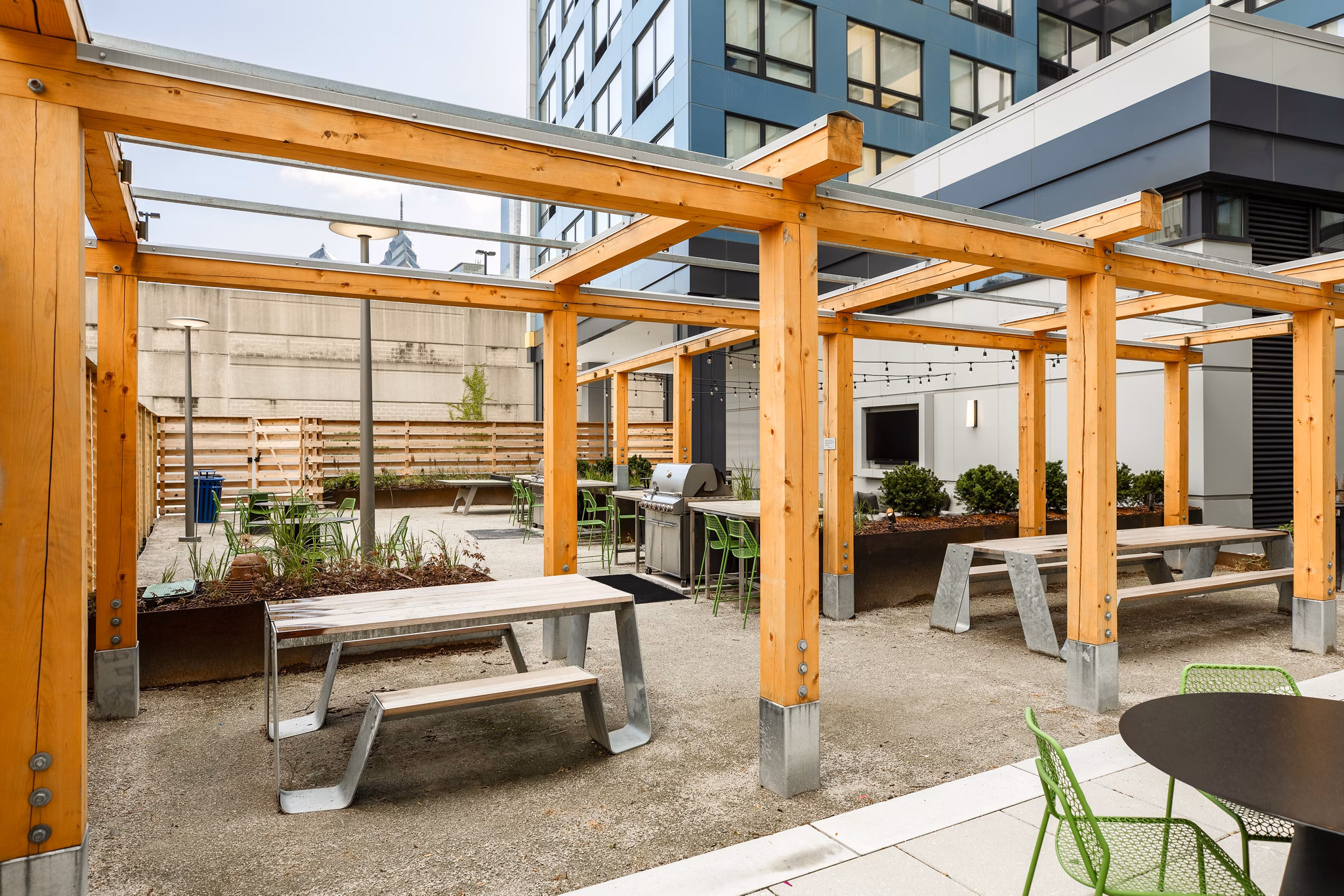 Outdoor grill area with modern seating at The Hamilton I Apartments, ideal for entertaining and enjoying luxury living in a Greystar property