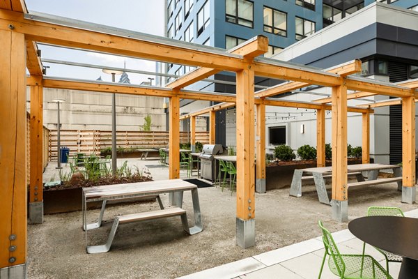 Outdoor grill area with modern seating at The Hamilton I Apartments, ideal for entertaining and enjoying luxury living in a Greystar property
