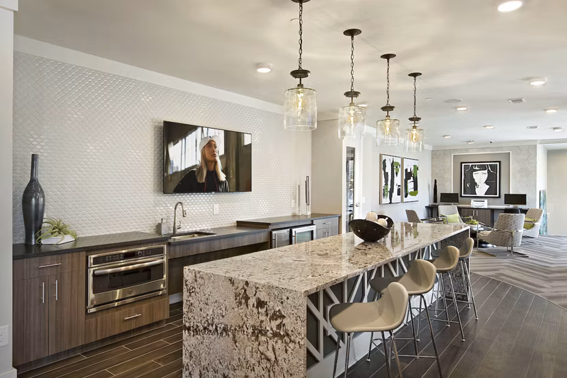 Clubhouse at Newbergh ATL Apartments: Modern lounge with gaming tables and cozy seating in luxury community