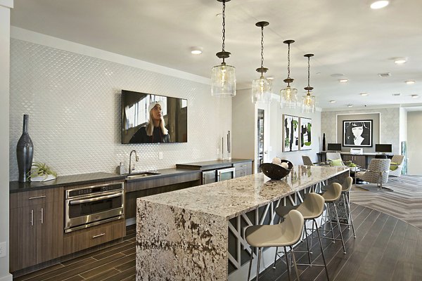 Clubhouse at Newbergh ATL Apartments: Modern lounge with gaming tables and cozy seating in luxury community