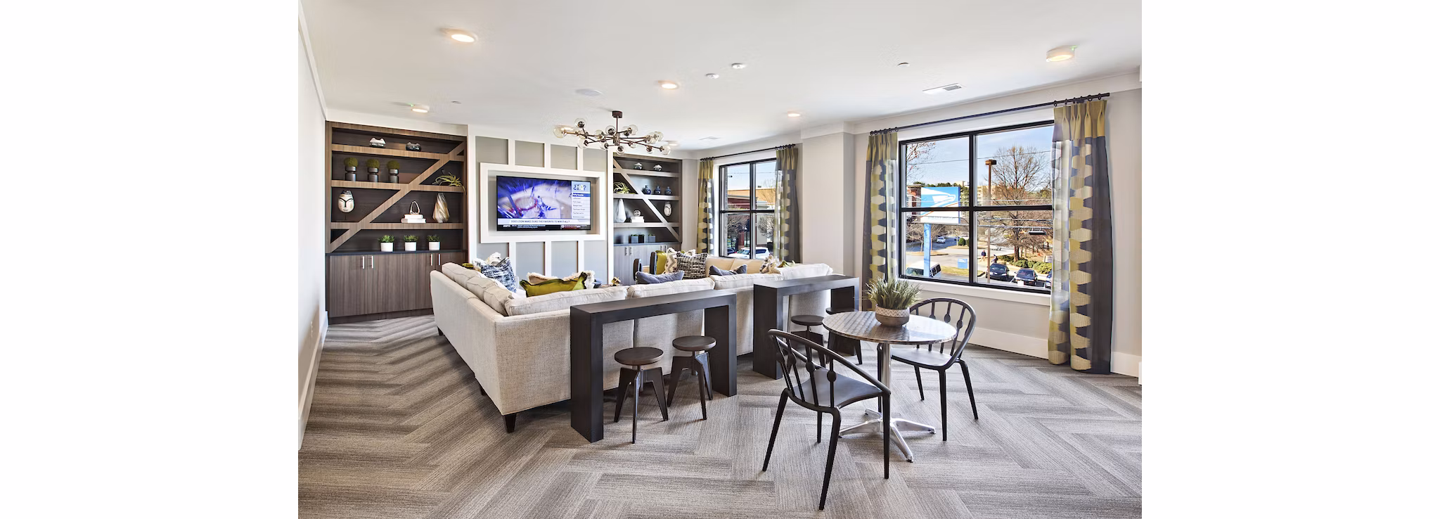 Newbergh ATL Apartments: Modern clubhouse with stylish seating areas and vibrant decor in Atlanta
