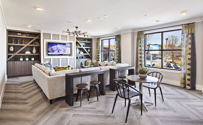 Newbergh ATL Apartments: Modern clubhouse with stylish seating areas and vibrant decor in Atlanta