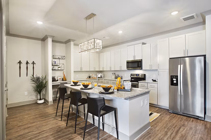 Modern kitchen with stainless steel appliances at Newbergh ATL Apartments