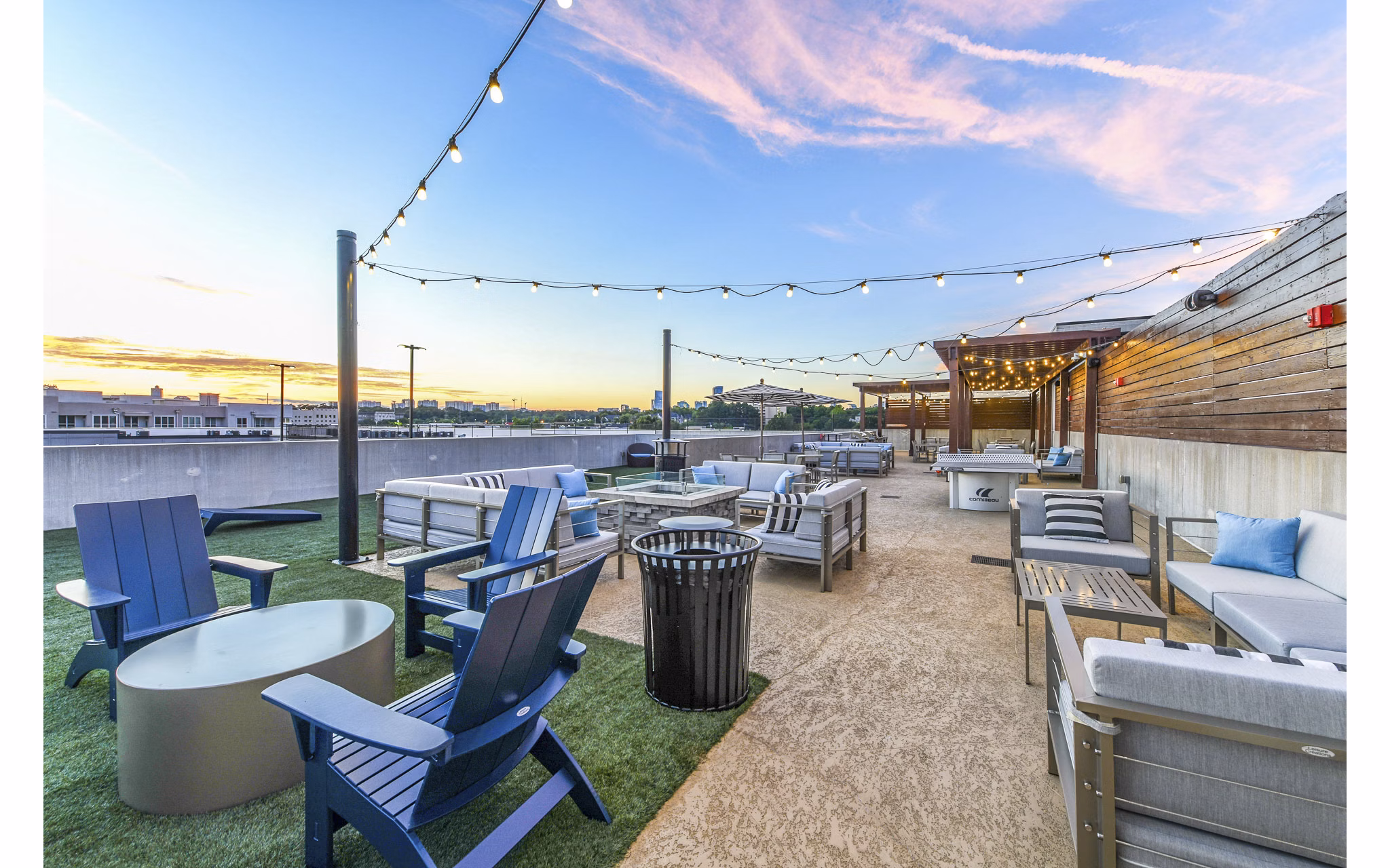 Fire pit with cozy seating on a patio at Newbergh ATL Apartments