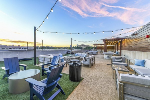 Fire pit with cozy seating on a patio at Newbergh ATL Apartments