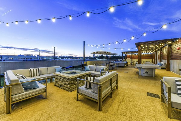 Outdoor lounge with fire pit and cozy seating at Newbergh ATL Apartments