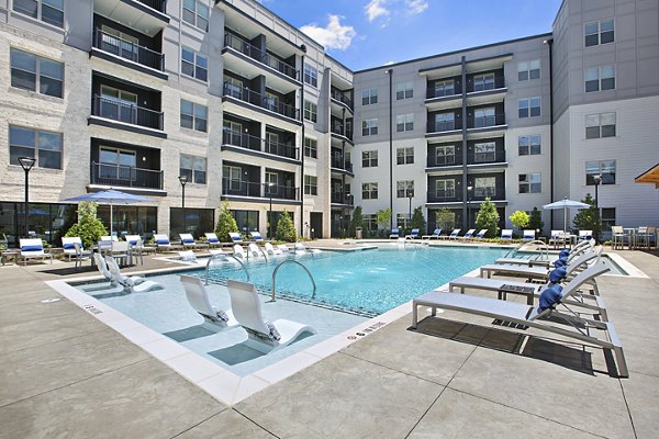 Resort-style pool with lounge seating at Newbergh ATL Apartments