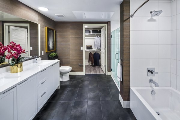 Luxurious bathroom featuring marble countertops and elegant fixtures at Highwater Apartments