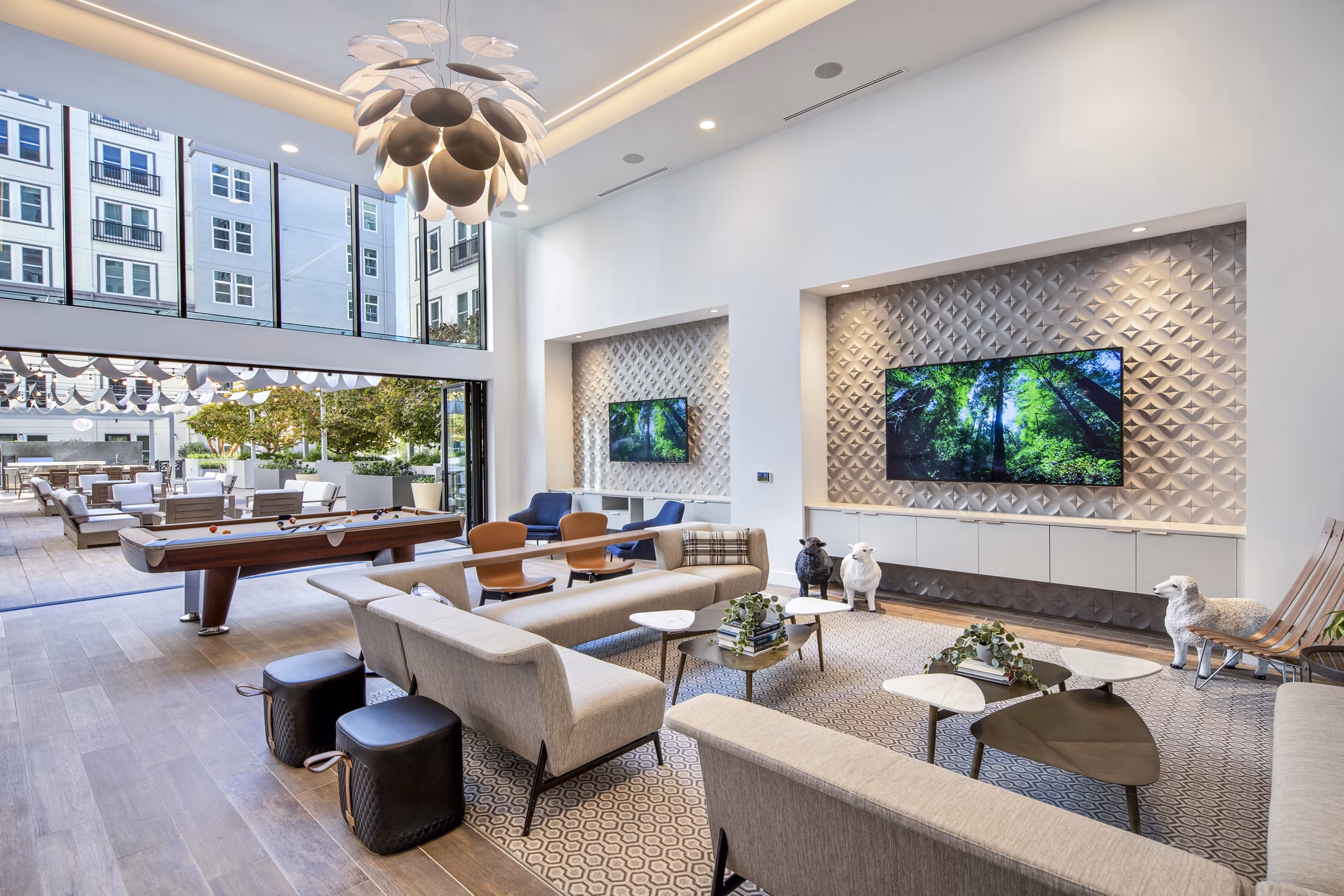 Game room with modern furnishings and pool table at Highwater Apartments luxury living