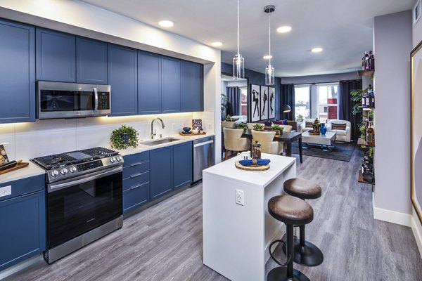 Modern kitchen with stainless steel appliances at Highwater Apartments, a luxury property by Greystar