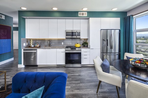 Modern kitchen with stainless steel appliances at Highwater Apartments