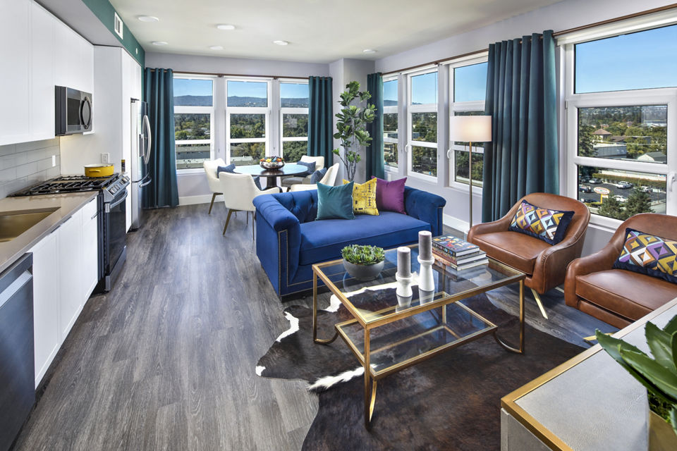 Spacious living room with modern decor and abundant natural light at Highwater Apartments