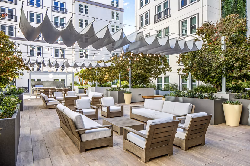 Open-air patio featuring modern seating and greenery at Highwater Apartments