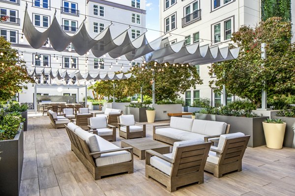 Open-air patio featuring modern seating and greenery at Highwater Apartments