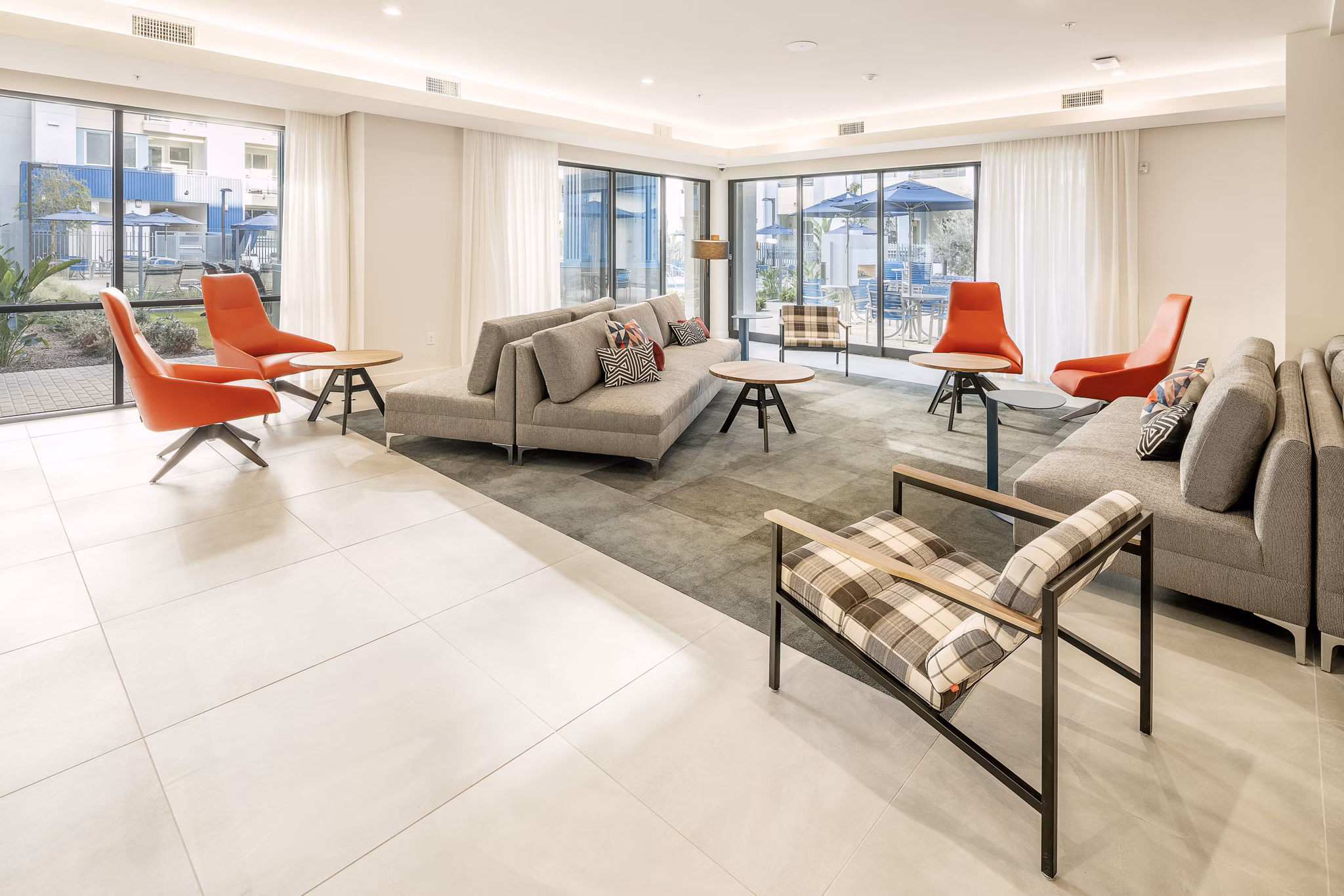 Modern clubhouse with plush seating and large windows at Parallel Apartments, a Greystar luxury community