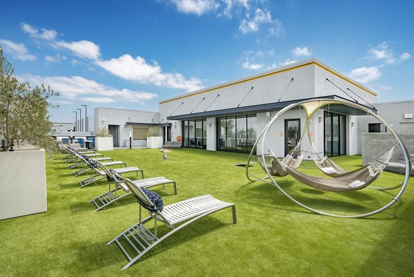 Relaxing courtyard with lush greenery and seating at Parallel Apartments