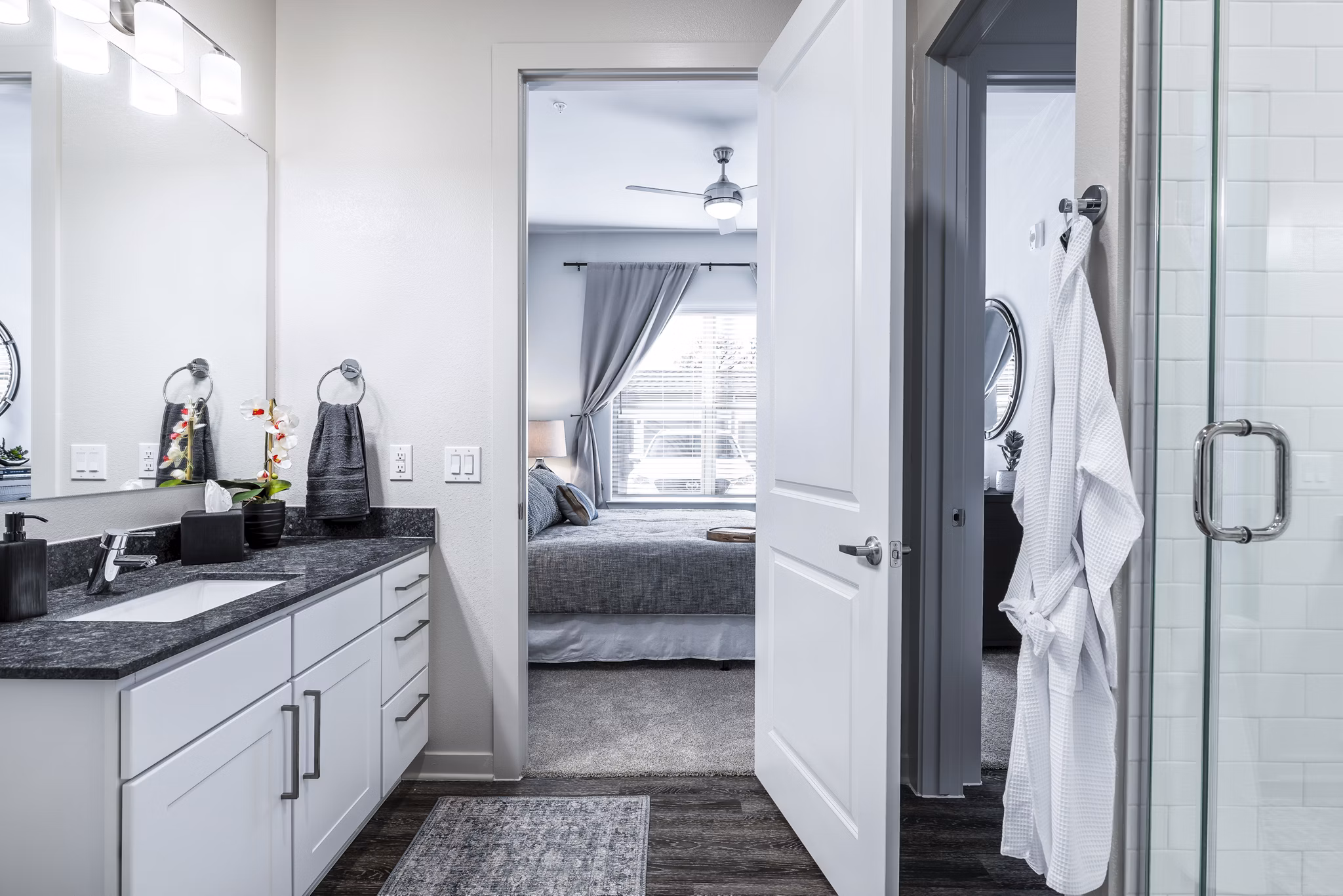 Luxurious bathroom with double vanity and modern fixtures at Overture River District Apartments