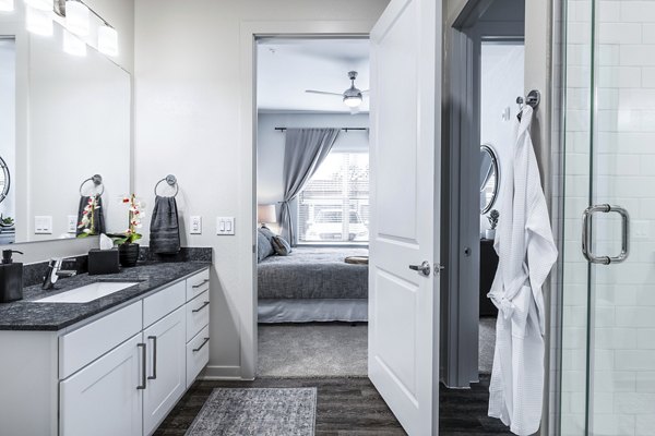 Luxurious bathroom with double vanity and modern fixtures at Overture River District Apartments