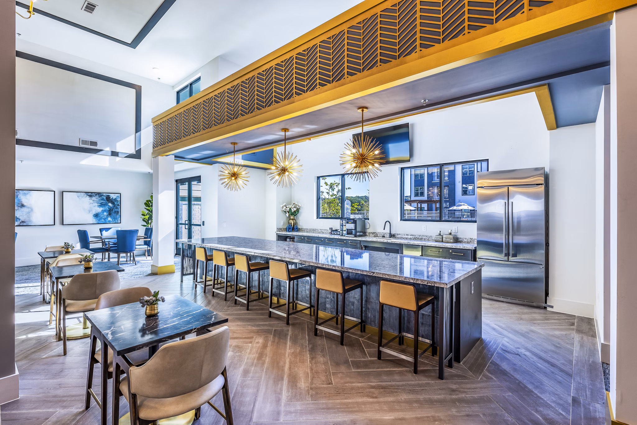 Clubhouse kitchen featuring modern appliances and island counter at Overture River District Apartments