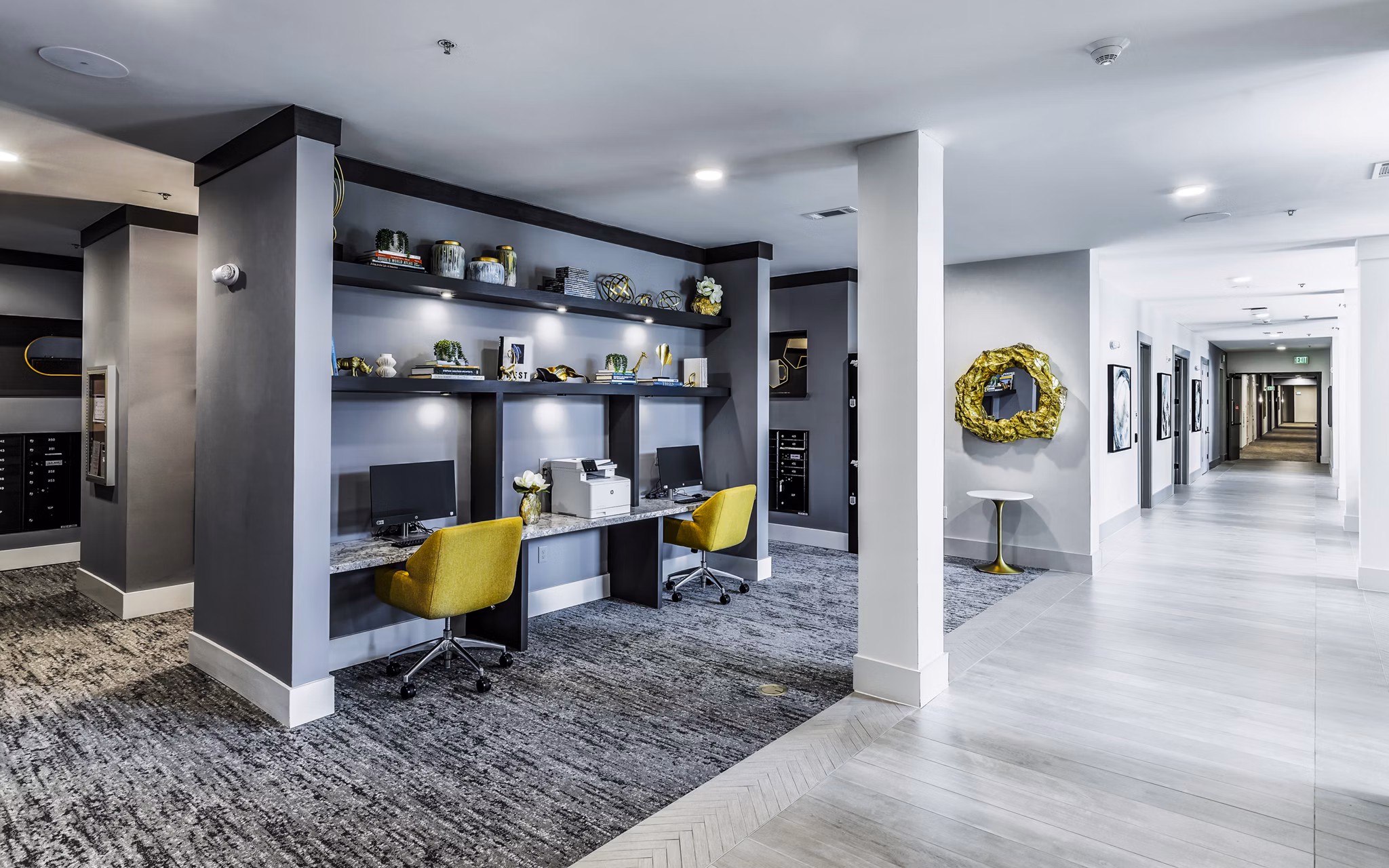 Clubhouse business center featuring modern workstations at Overture River District Apartments