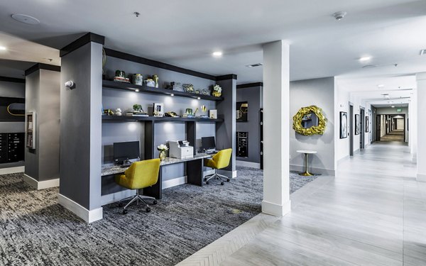 Clubhouse business center featuring modern workstations at Overture River District Apartments