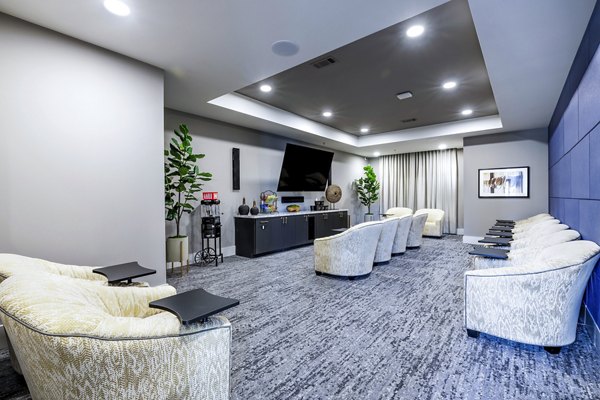 Clubhouse theater with plush seating at Overture River District Apartments, luxury living destination