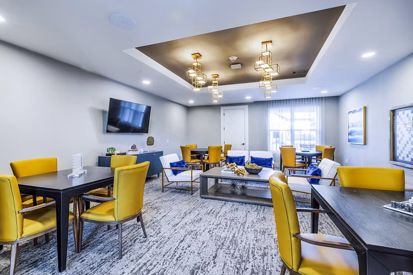 Clubhouse game room featuring billiards and lounge seating at Overture River District Apartments