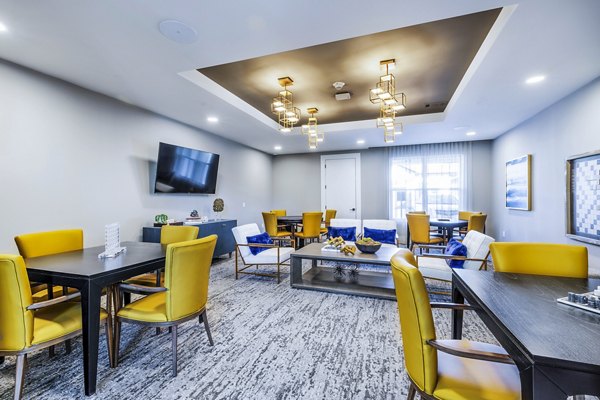 Clubhouse game room featuring billiards and lounge seating at Overture River District Apartments