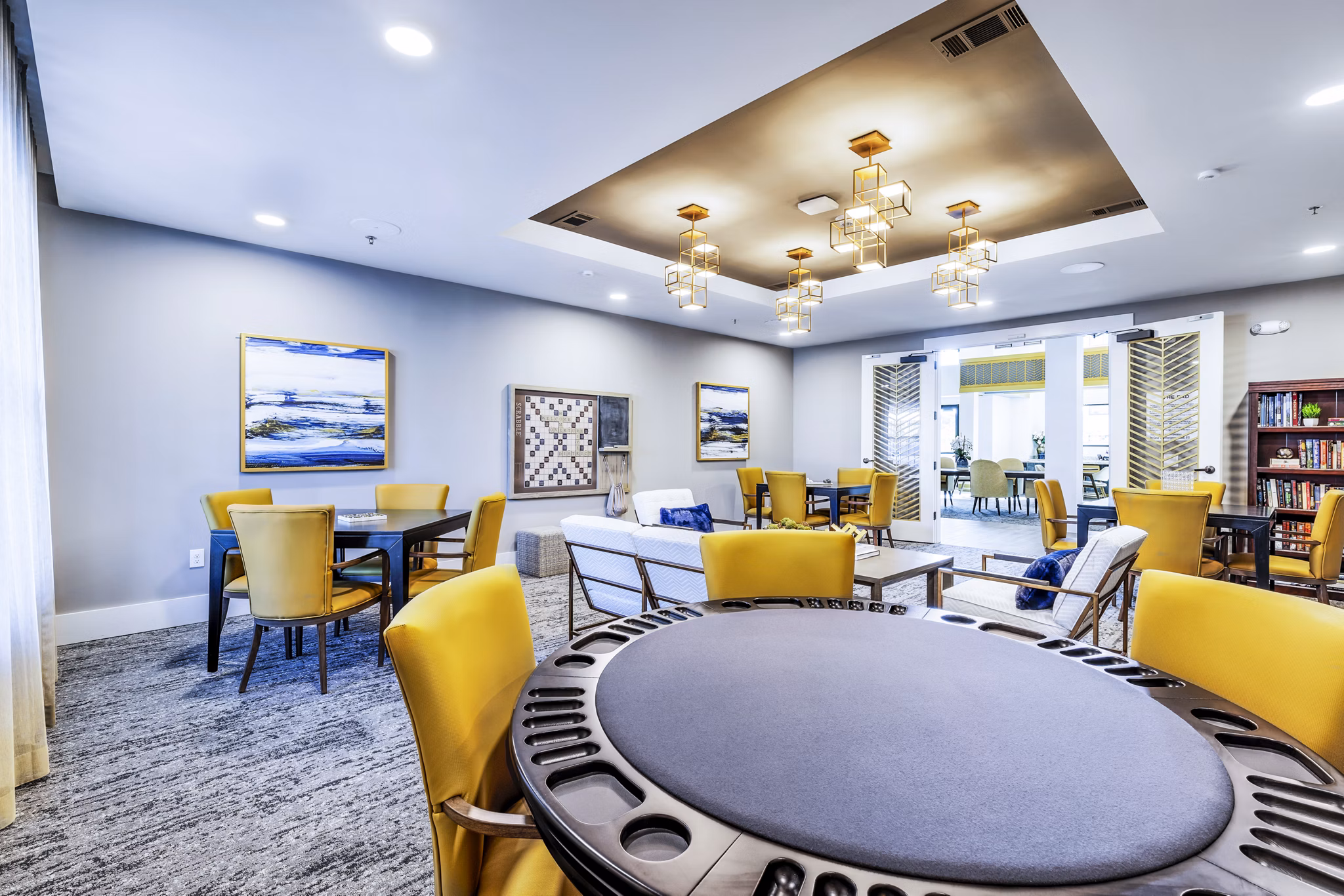 Clubhouse game room with billiards and lounge chairs at Overture River District Apartments, perfect for leisure and socializing