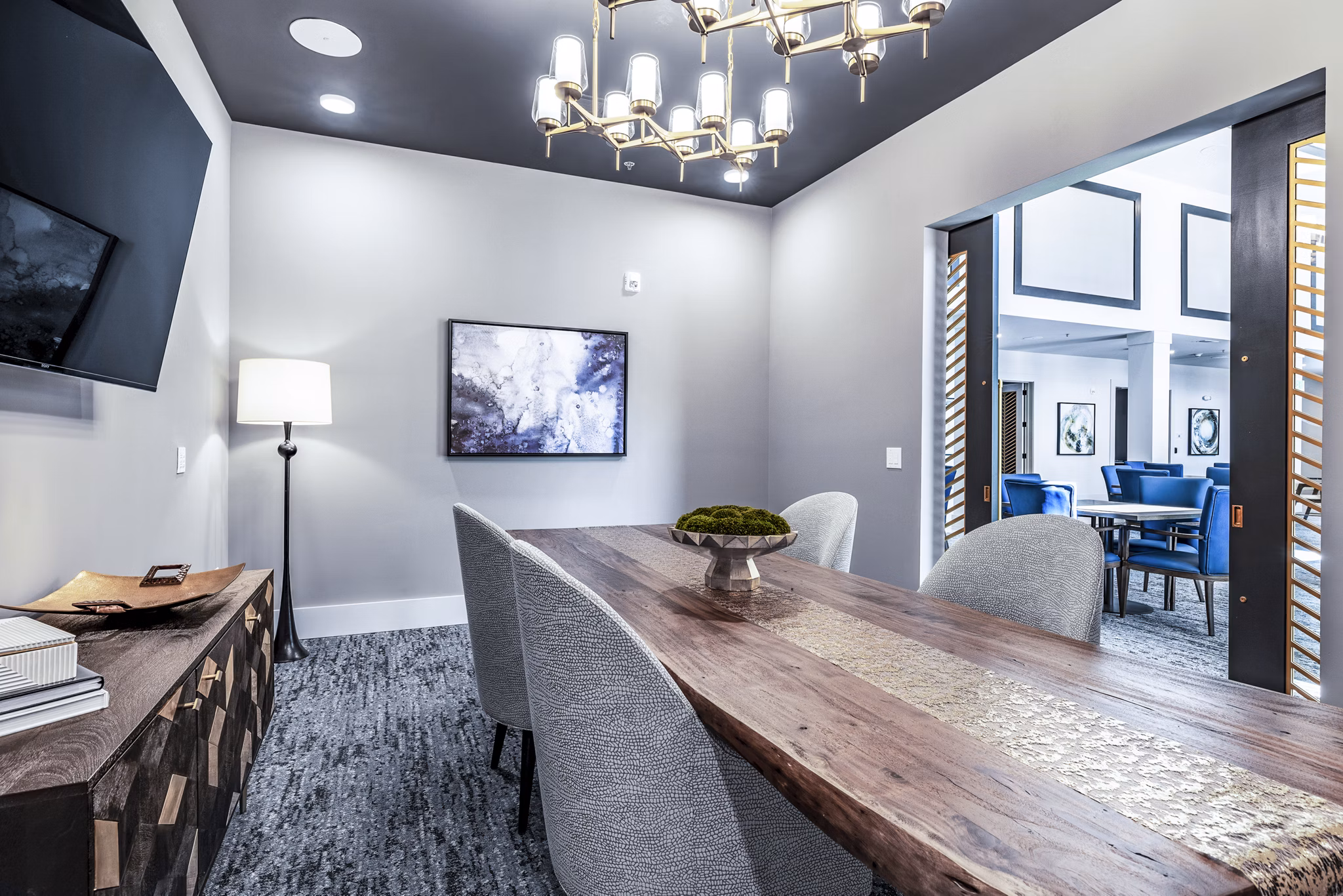 Modern clubhouse meeting facility with elegant seating and large windows at Overture River District Apartments