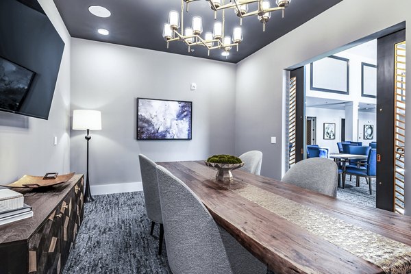 Modern clubhouse meeting facility with elegant seating and large windows at Overture River District Apartments