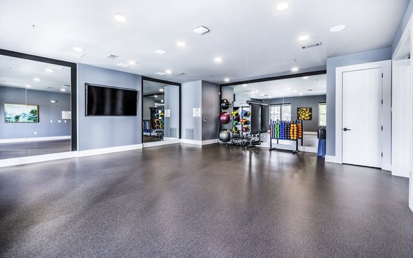 Modern yoga and spin studio filled with equipment at Overture River District Apartments, ideal for fitness enthusiasts