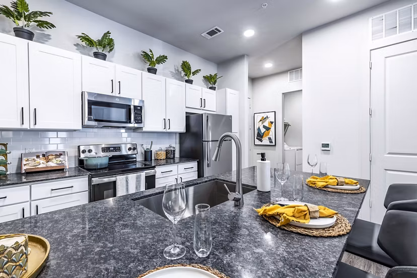 Modern kitchen featuring stainless steel appliances at Overture River District Apartments