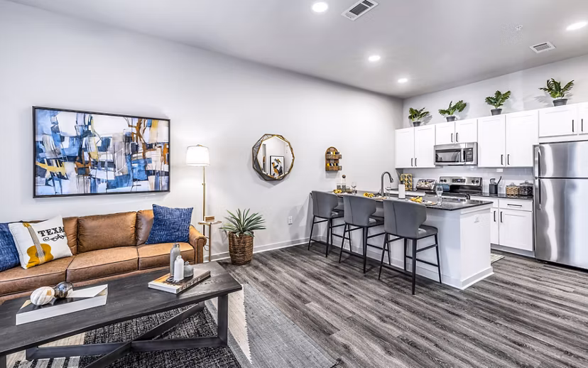 Open-concept kitchen and living room with modern finishes at Overture River District Apartments, luxury apartments in a vibrant community