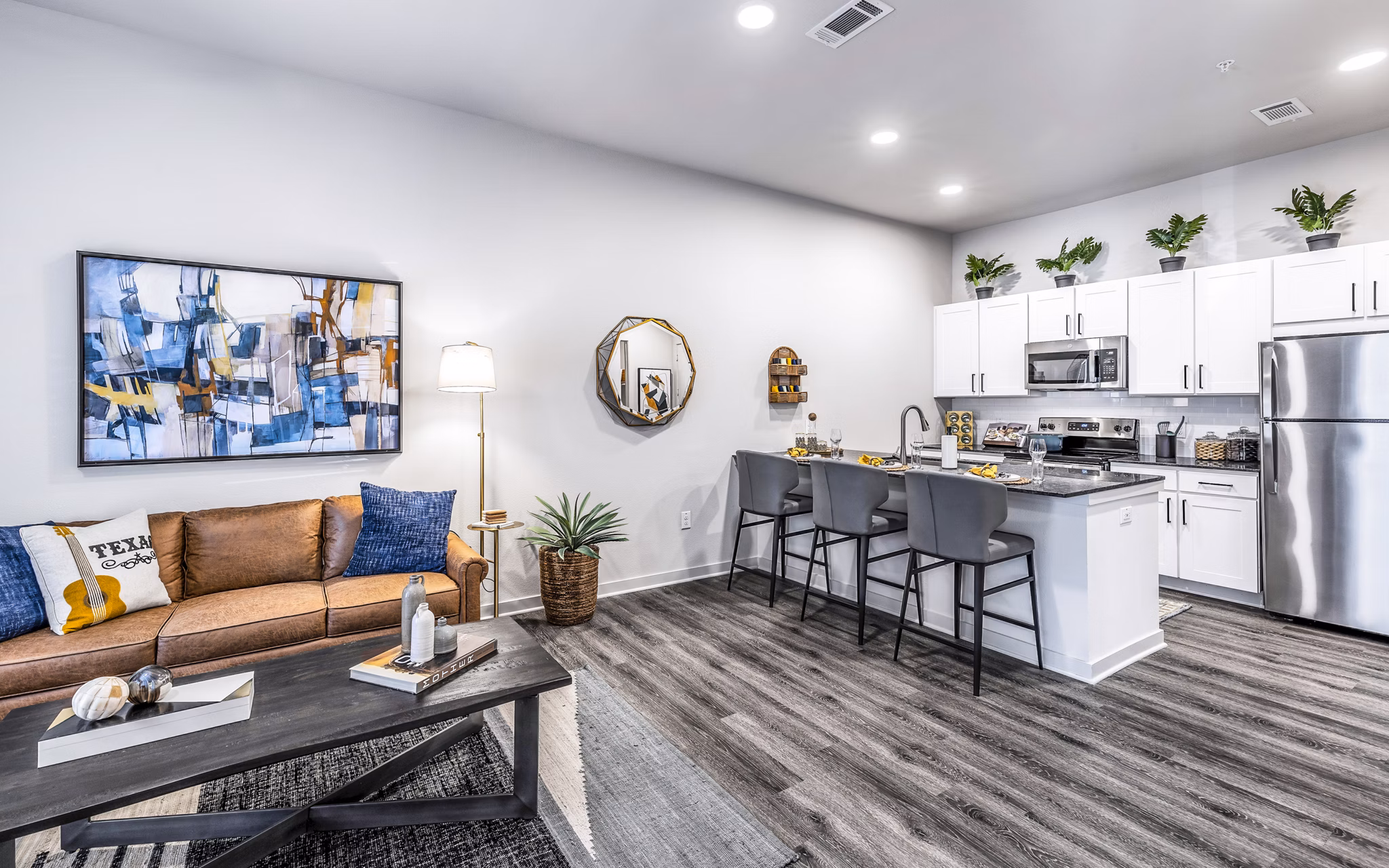 Open-concept kitchen and living room with modern finishes at Overture River District Apartments, luxury apartments in a vibrant community