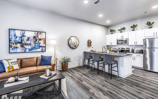 Open-concept kitchen and living room with modern finishes at Overture River District Apartments, luxury apartments in a vibrant community