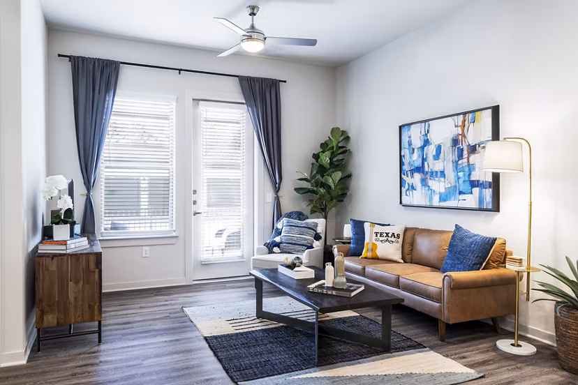 Living room with modern decor and natural light at Overture River District Apartments