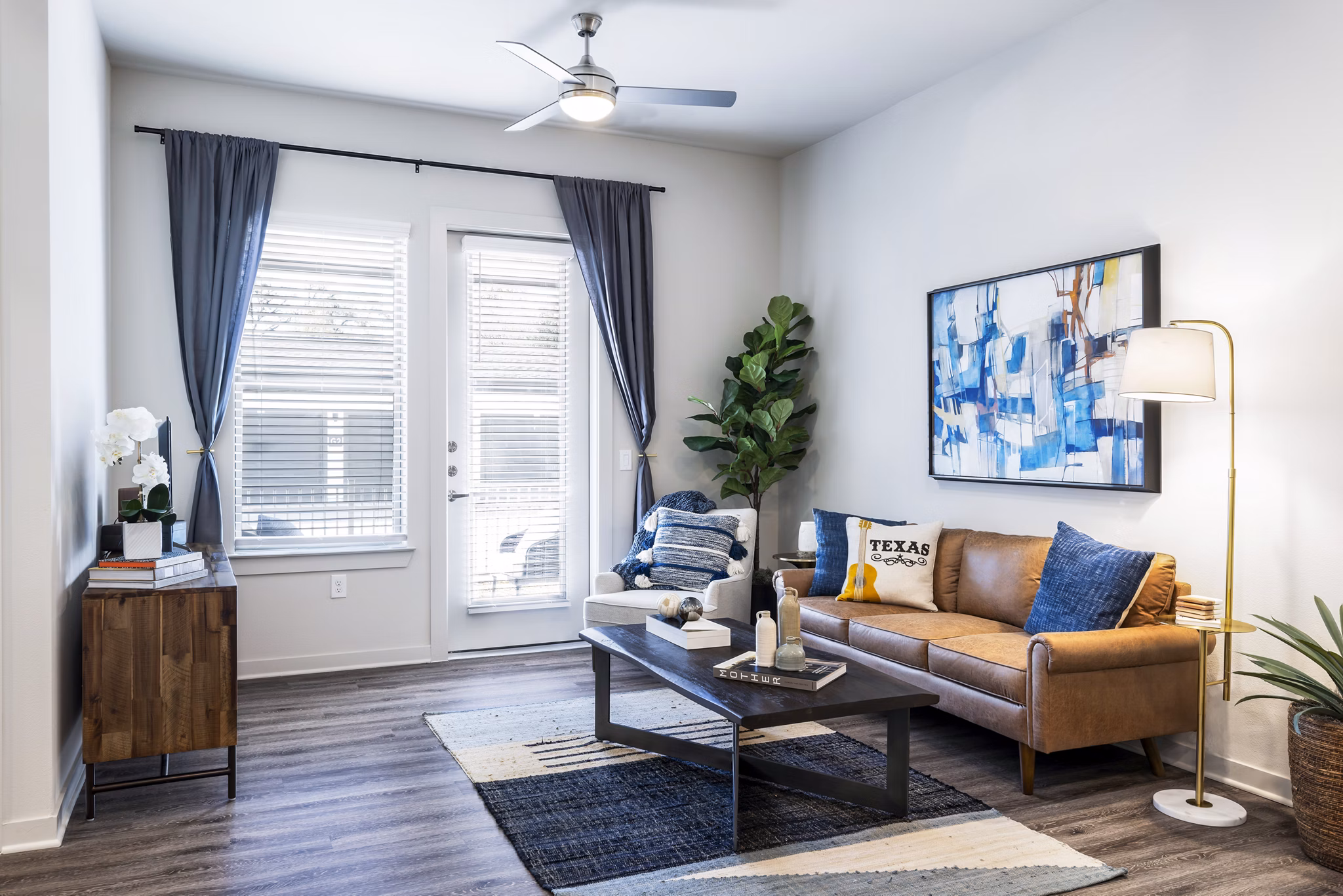 Living room with modern decor and natural light at Overture River District Apartments