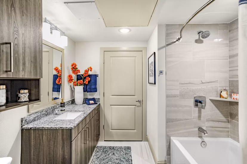Elegant bathroom with modern fixtures at Domain Town Center Apartments, featuring porcelain tiles and spacious vanity