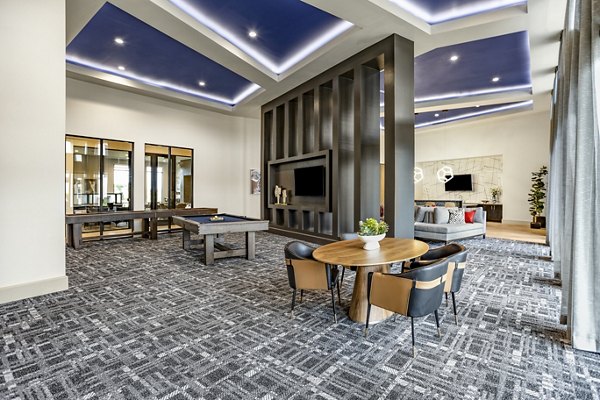 Clubhouse at Domain Town Center Apartments featuring modern design and ample seating for community gatherings in luxury surroundings