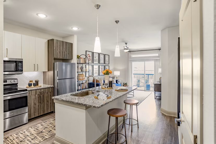 Modern kitchen with stainless steel appliances in Domain Town Center Apartments