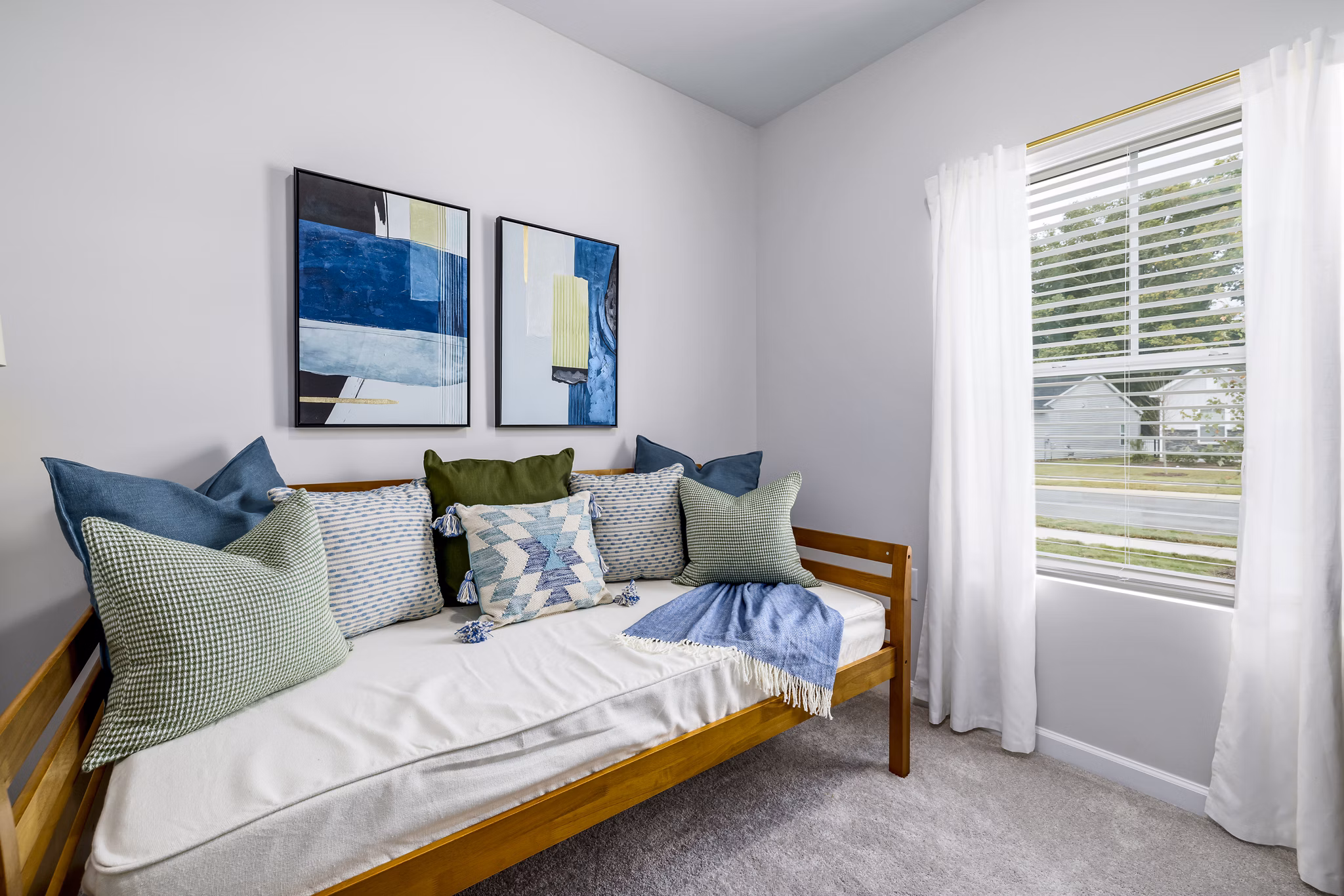 Spacious bedroom with soft lighting and modern decor in Abode at Geneva Apartment Townhomes