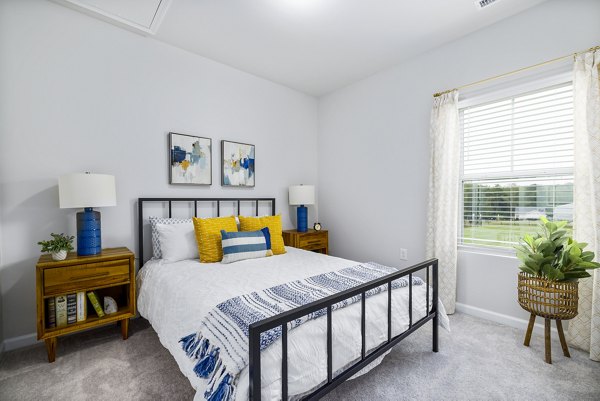 Bedroom featuring contemporary design and cozy decor at Abode at Geneva Apartment Townhomes