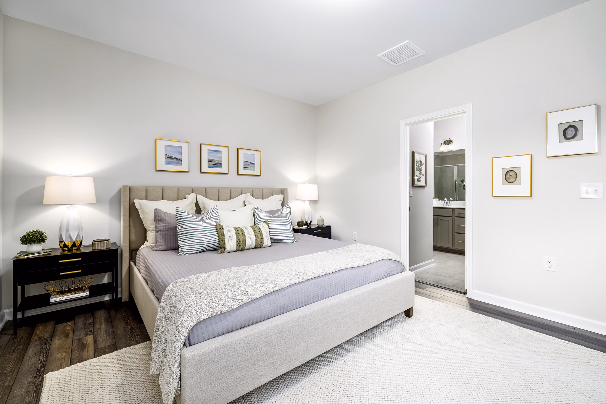 Cozy bedroom with modern decor and ample natural light in Abode at Geneva Apartment Townhomes