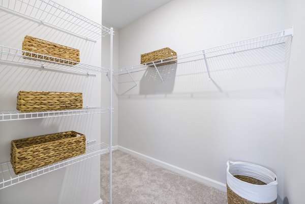 Bedroom closet with built-in shelving in Abode at Geneva Apartment Townhomes