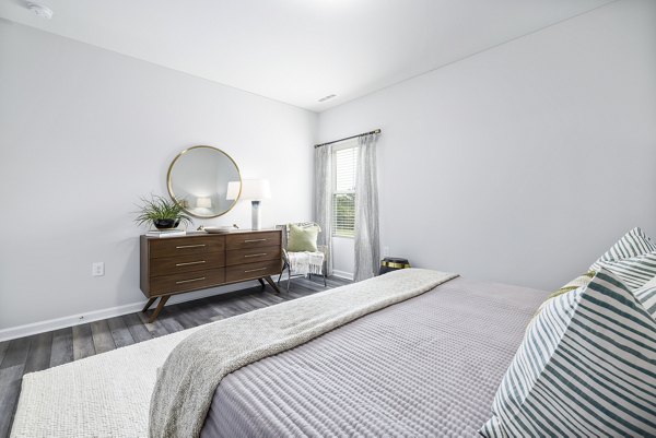 Cozy bedroom with modern decor in Abode at Geneva Apartment Townhomes