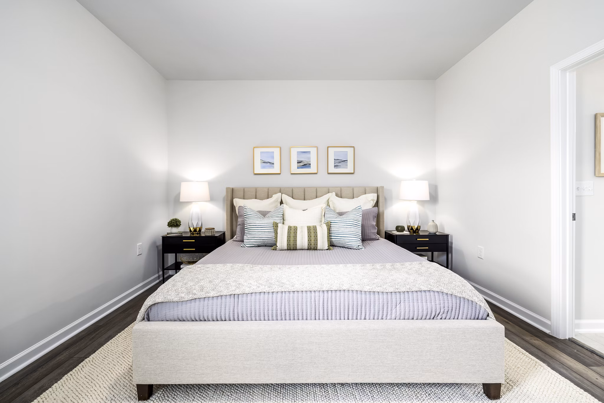 Modern bedroom with sleek furnishings at Abode at Geneva Apartment Townhomes