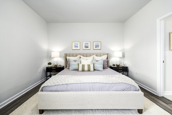 Modern bedroom with sleek furnishings at Abode at Geneva Apartment Townhomes